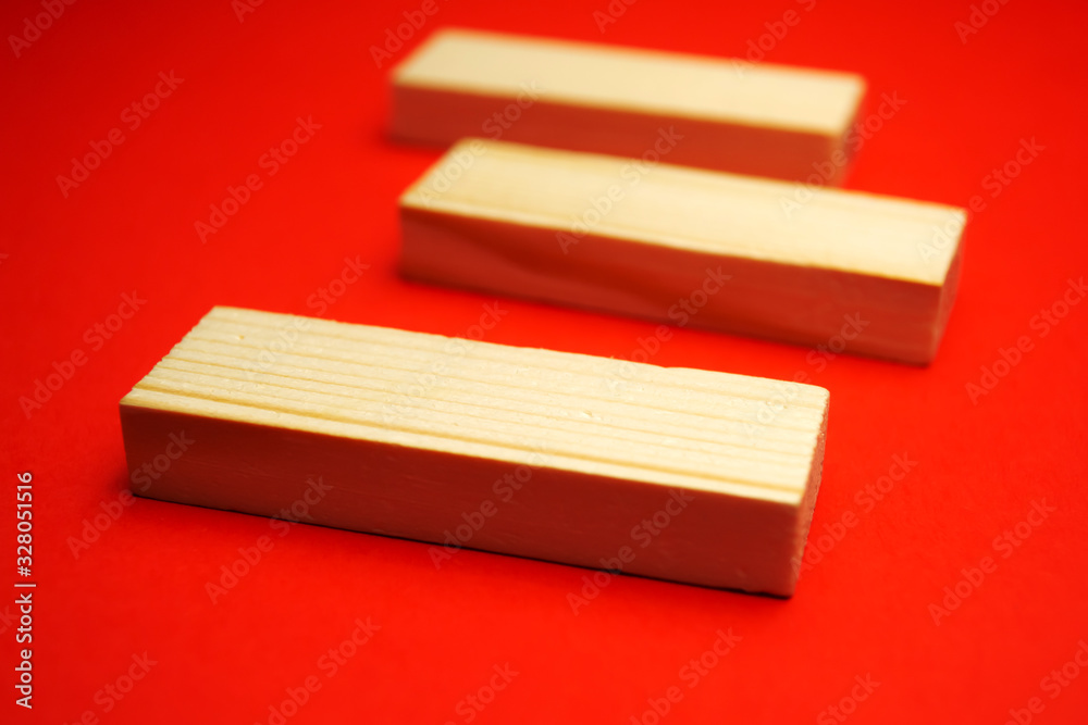 Three wood blocks on a red background Three wood blocks on a red background