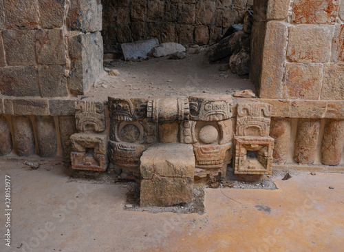 Traditional Mayan symbols. Fragment of palace of the Masks (Codz Poop) in Kabah Mayan archaeological site. Yucatan. Mexico. photo