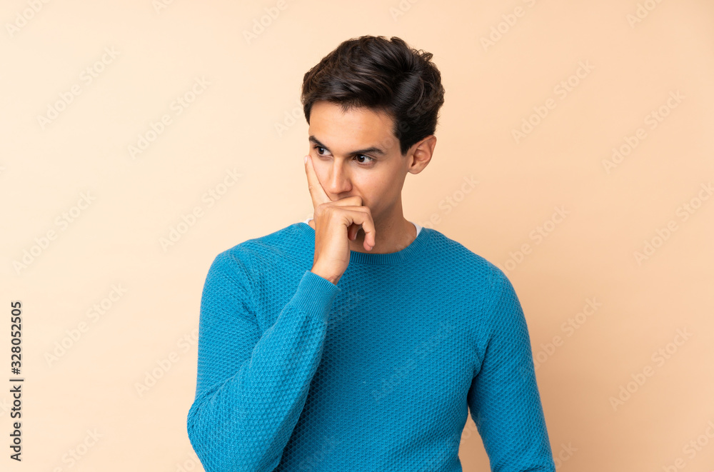 Man over isolated background having doubts and with confuse face expression Man over isolated background having doubts and with confuse face expression