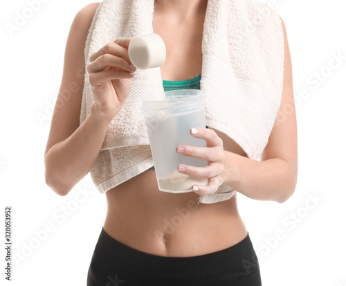 Sporty young woman with protein on white background