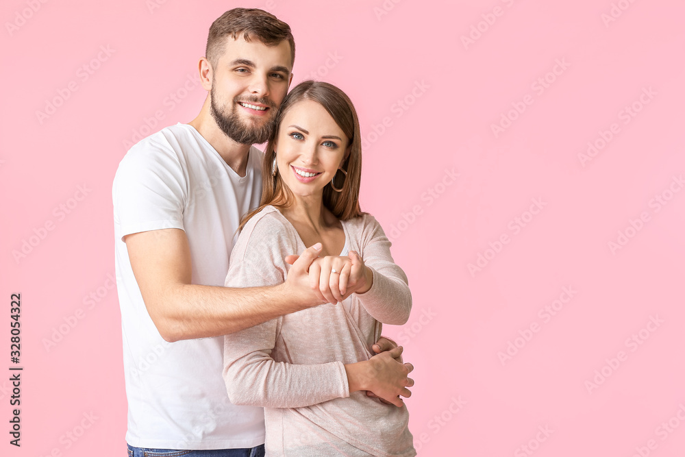Happy engaged young couple on color background