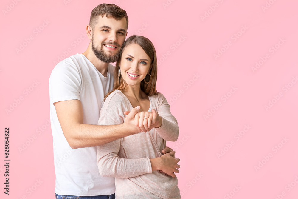 Happy engaged young couple on color background Happy engaged young couple on color background