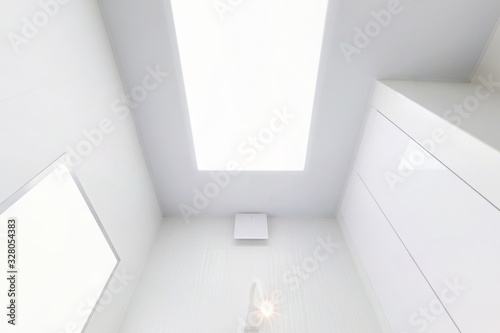Wallpaper Mural looking up on suspended ceiling with halogen spots lamps and drywall construction in empty room in apartment or house. Stretch ceiling white and complex shape. Torontodigital.ca