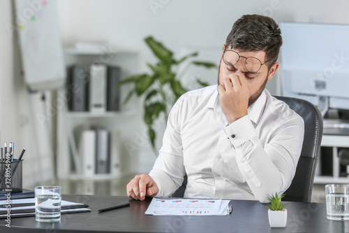 Tableau sur toile Young worried businessman in office