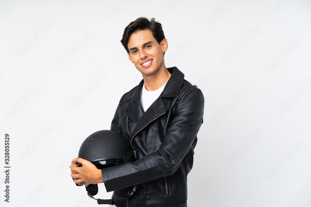 Man holding a motorcycle helmet over isolated white background looking to the side Man holding a motorcycle helmet over isolated white background looking to the side