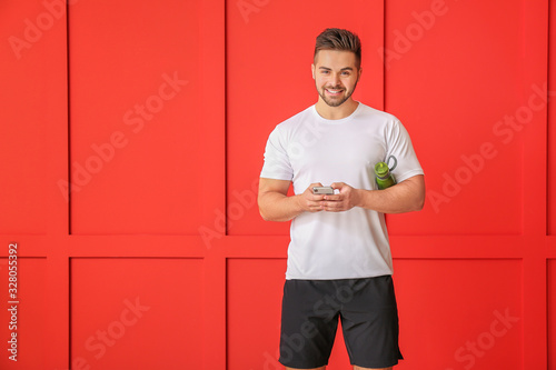Sporty man with mobile phon...