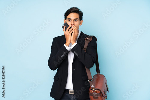 Businessman over isolated blue background with surprise facial expression