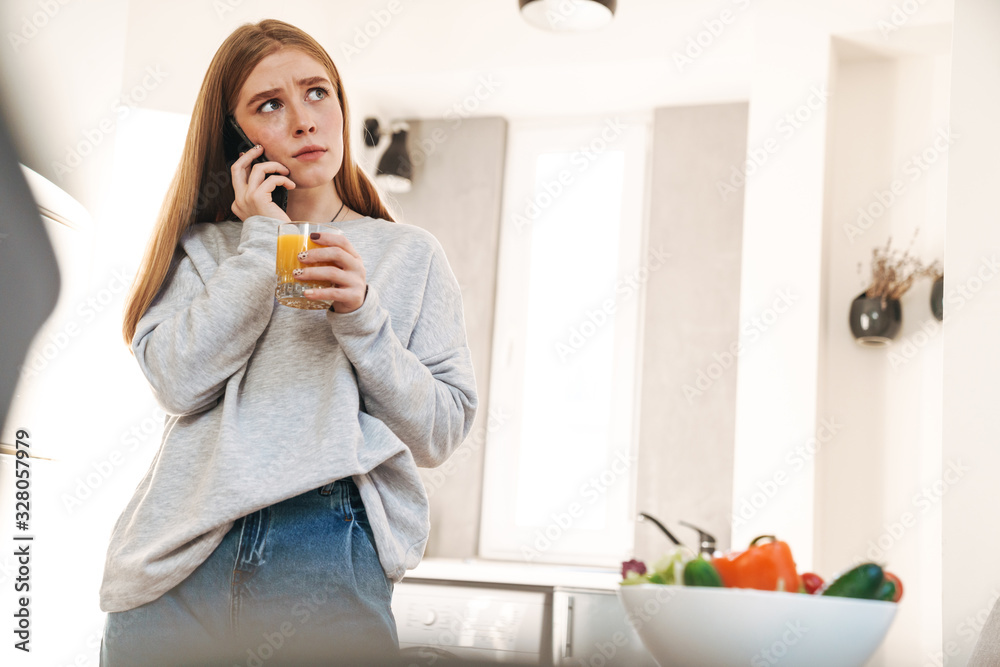 Confused girl talking by mobile phone Confused girl talking by mobile phone