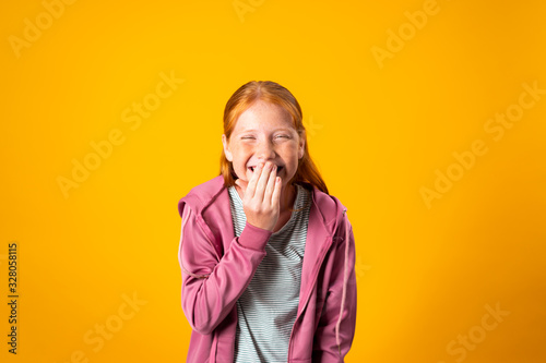 A Shy Red-Haired White Girl Laughs Nervously Covering Her Mouth