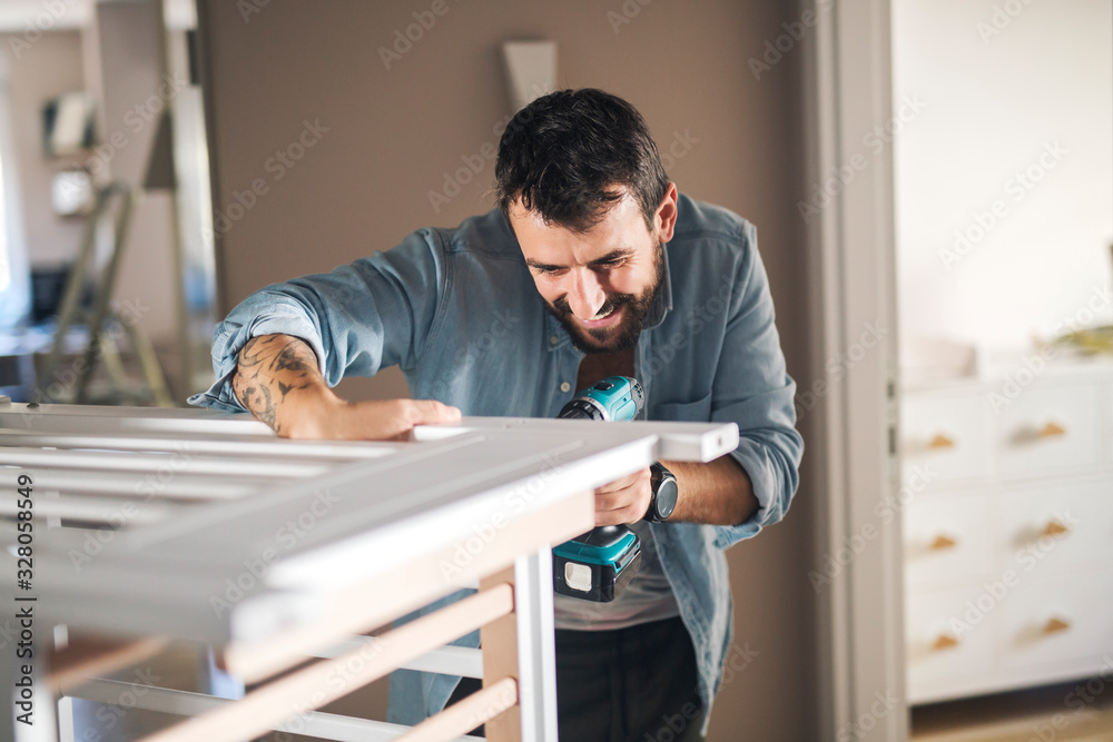 Man assembling slats of baby crib. Man assembling slats of baby crib.