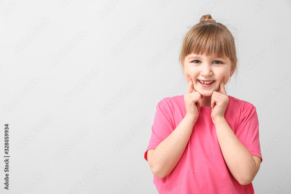 Smiling little girl on light background Smiling little girl on light background