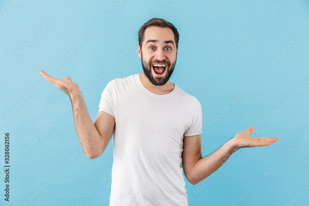 Portrait of a young cheerful bearded man wearing t-shirt Portrait of a young cheerful bearded man wearing t-shirt