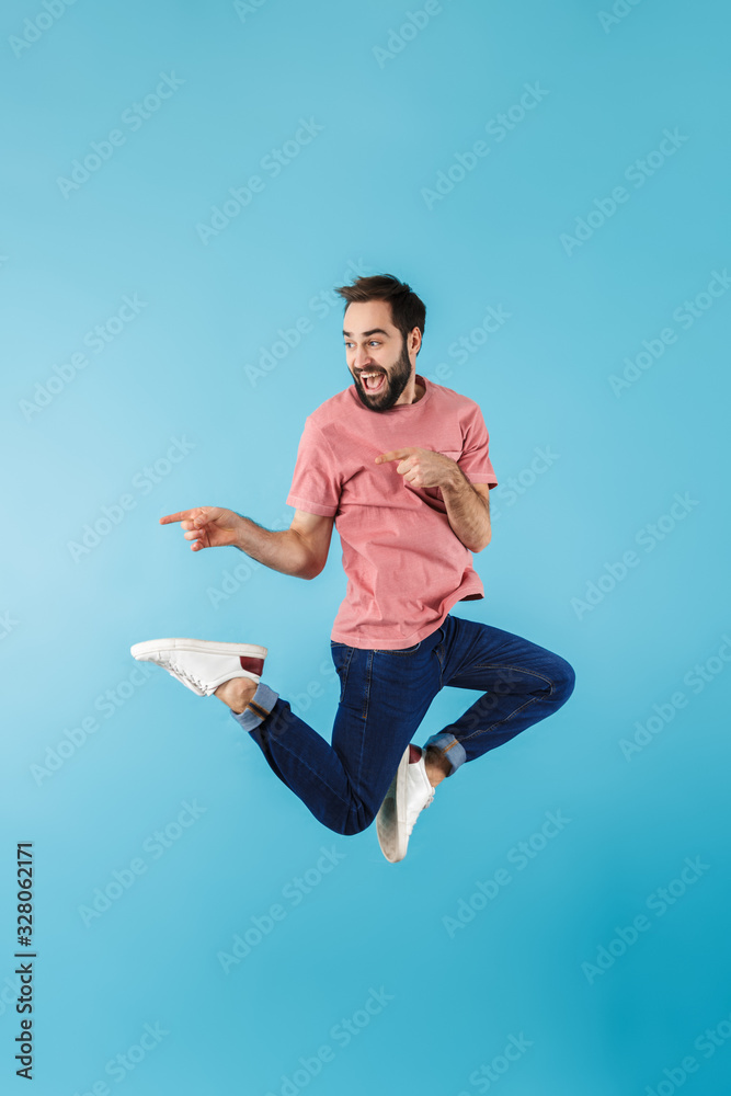 Portrait of a young cheerful bearded man wearing t-shirt