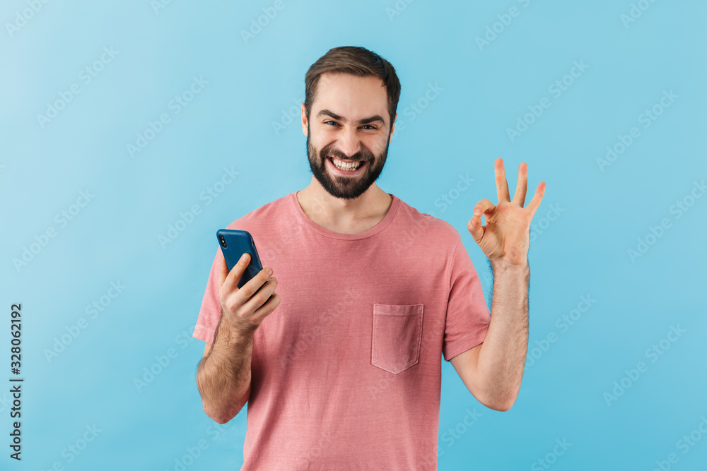 Portrait of a young cheerful bearded man wearing t-shirt Portrait of a young cheerful bearded man wearing t-shirt