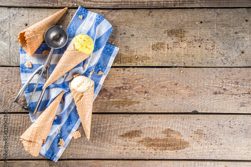 Set of various homemade colorful ice cream with icecream waffle cones on wooden background, copy space top view