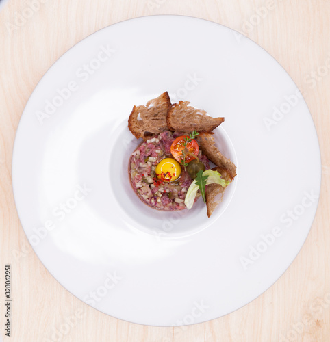 Marbled beef tartare on a white plate