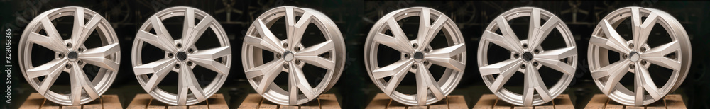 a lot of alloy wheels on a black background, silver aluminum wheels are new. Long layout for the site header