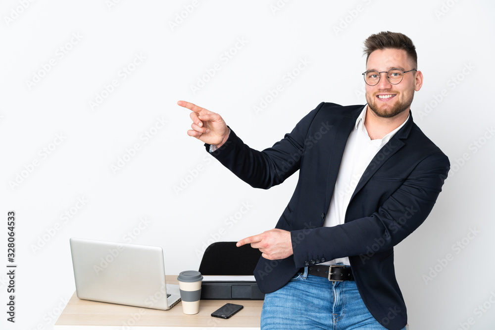 Russian man in a office isolated on white background pointing finger to the side and presenting a product