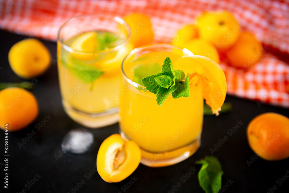 cups apricot lemonade with mint, fresh apricots, orange towel cups apricot lemonade with mint, fresh apricots, orange towel