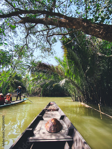 Travel on a wooden boat in the floating market.