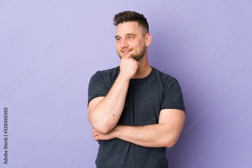 Russian handsome man over isolated background looking to the side and smiling