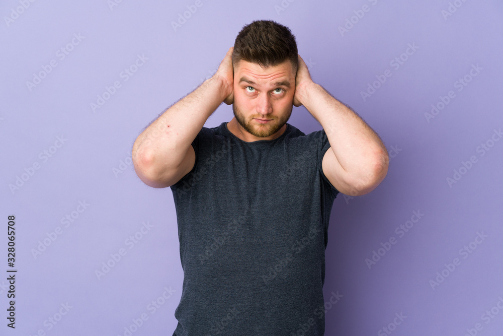 Russian handsome man over isolated background frustrated and covering ears Russian handsome man over isolated background frustrated and covering ears