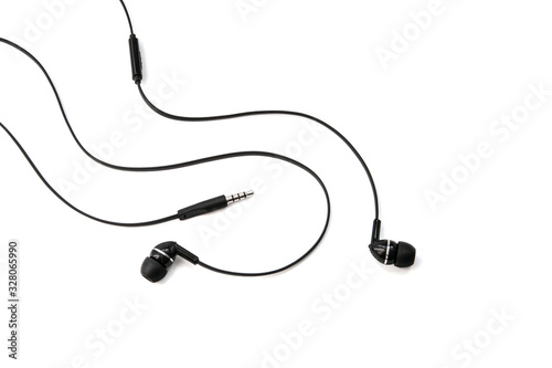 Wired earphones for listening music and sounds on portable devices isolated on white background. Black audio headphones headset. In-ear vacuum earplugs for music lovers.