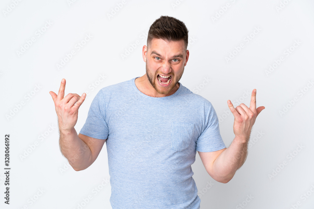 Fototapeta premium Russian handsome man over isolated background making horn gesture