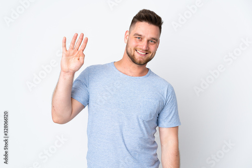 Russian handsome man over isolated background saluting with hand with happy expression