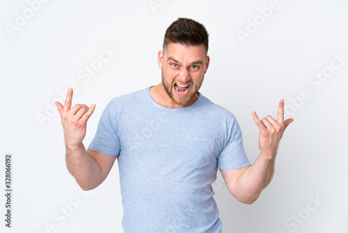 Russian handsome man over isolated background making horn gesture