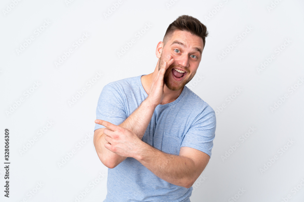 Russian handsome man over isolated background pointing to the side to present a product and whispering something Russian handsome man over isolated background pointing to the side to present a product and whispering something