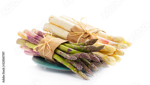 Green and white asparagus on a green plate, isolated on white