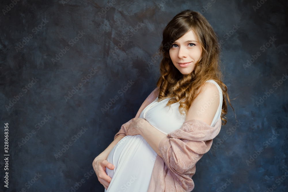 Expectant mother on dark background. Maternity fashion, femininity, pregnancy concept. Expectant mother on dark background. Maternity fashion, femininity, pregnancy concept.