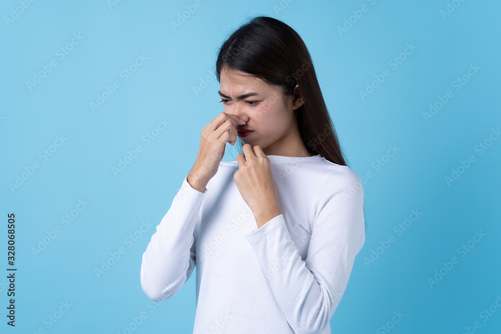 Woman smelling bad from her shirt because dirty laundry. Woman smelling bad from her shirt because dirty laundry.