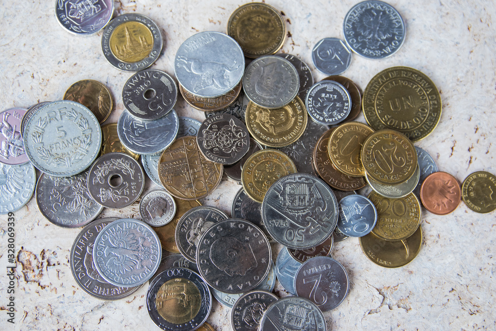 Pile of gold and silber coins on the natural background.