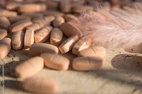 Pink tabletten on the natural background. photo