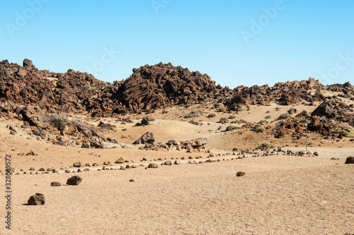 Landscape of the ancient Caldera of the Teide volcano. Trekking path leading to the desert.