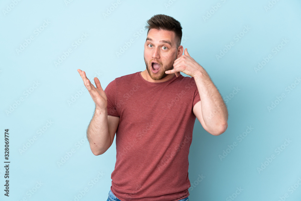 Russian handsome man over isolated background making phone gesture and doubting Russian handsome man over isolated background making phone gesture and doubting
