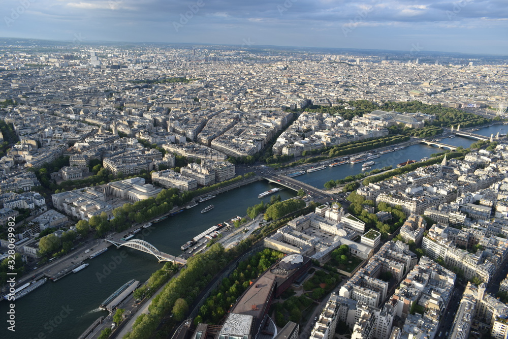 Panoramic aerial view of Paris from the top of the Eiffel Tower - Outstanding view in a beautiful sunny day before the sunset - France, Europe
