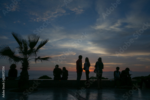 Sunset at Miraflores coast. Lima Peru. People and palmtrees