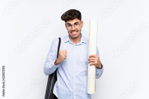 Young architect man over isolated white background celebrating a victory