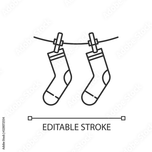 Outside drying pixel perfect linear icon. Laundry, clothes drying, socks hanging on clothesline. Thin line customizable illustration. Contour symbol. Vector isolated outline drawing. Editable stroke