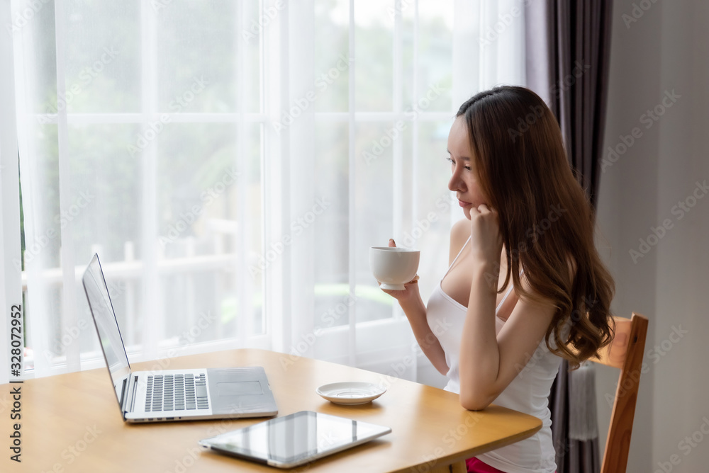 Lazy woman drinking morning coffee at home.