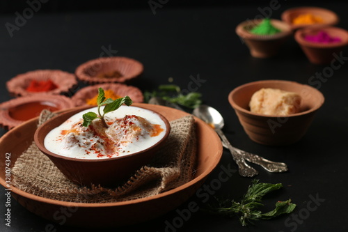 Dahi vada (Deep fried balls served with curd), thandai are well known indian Holi snack. (Holi Concept)