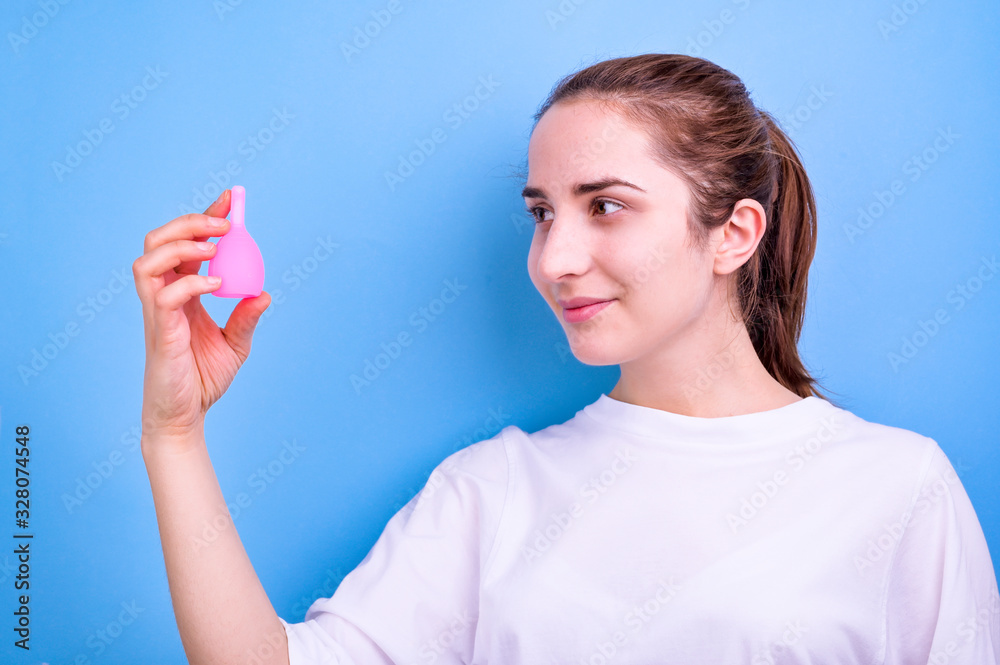 A shot of the menstrual cup in the hands of a woman. Feminine and lifestyle. Young girl and modern hygiene products. Copy space A shot of the menstrual cup in the hands of a woman. Feminine and lifestyle. Young girl and modern hygiene products. Copy space