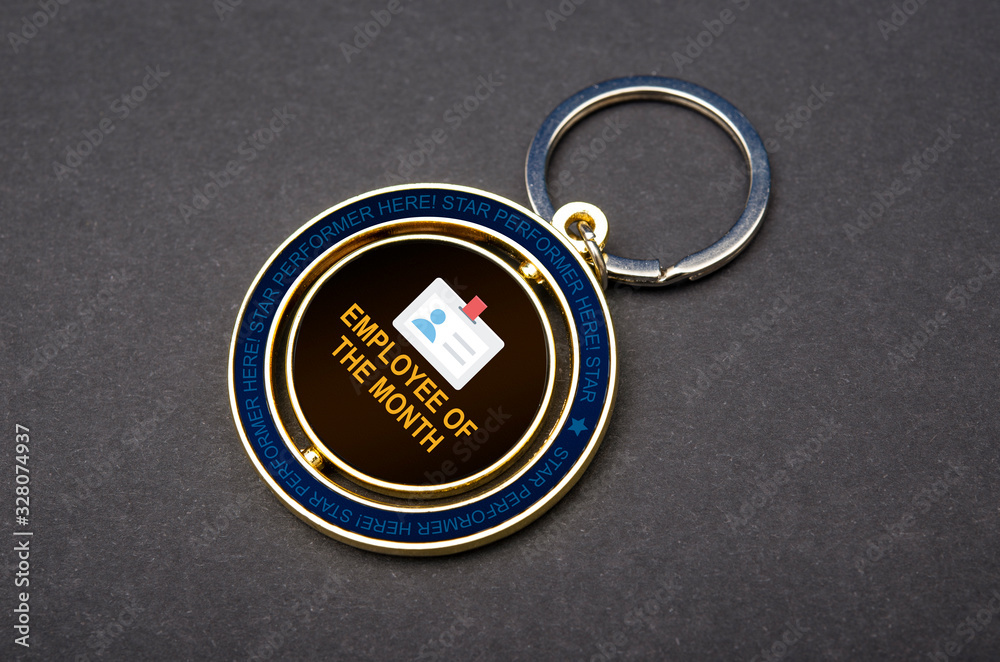 Close up view of employee of the month badge and Keychains with copy space