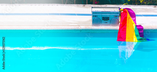 Radio cassette and rainbow flag in a pool