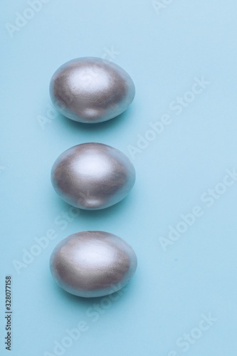 Silver easter eggs on a blue background.