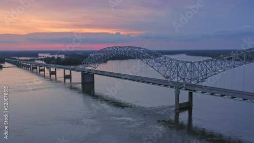 Aerial flying over traffic on the Hernando de Soto Bridge that crosses the Mississippi River at night. The bridge crosses into Arkansas. Memphis, Tennessee, USA photo