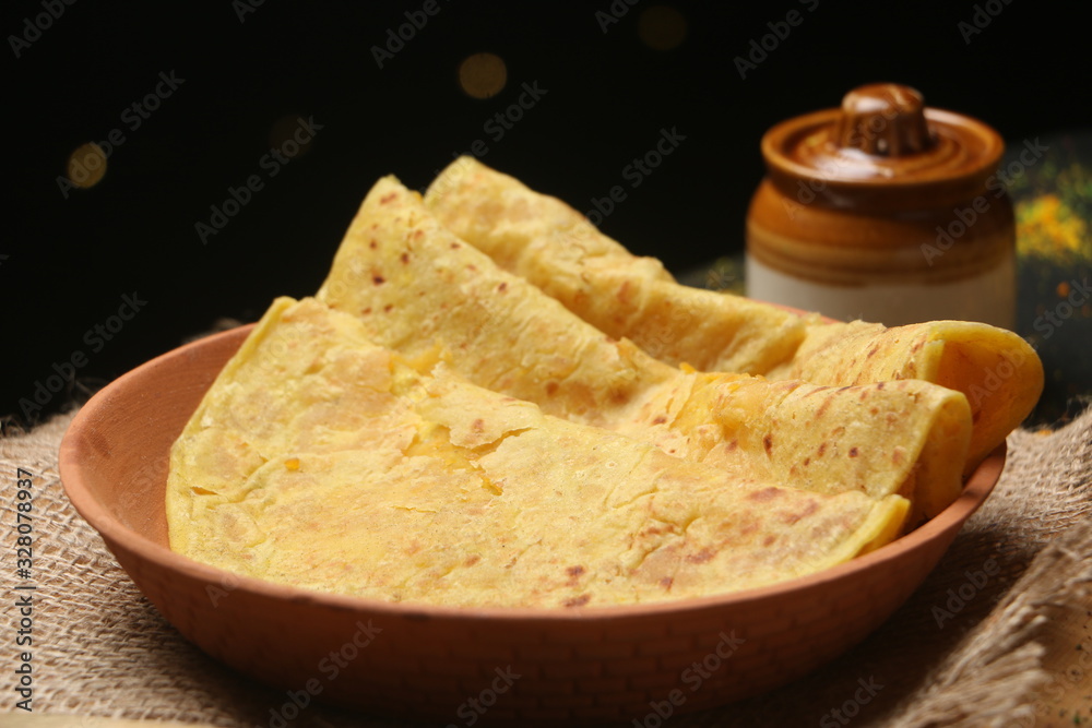 PopuIndian sweet bread known as Puran poli (Gram floor and jaggery stuffed bread), Dahi vada, thandai are well known indian Holi snack. (Holi Concept) PopuIndian sweet bread known as Puran poli (Gram floor and jaggery stuffed bread), Dahi vada, thandai are well known indian Holi snack. (Holi Concept)
